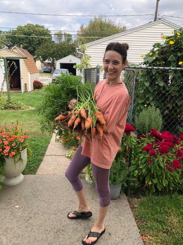 Vital Vines owner holding carrots